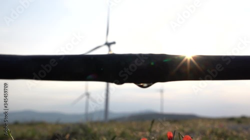 A drip irrigation system dribble in wind turbine  background. The concept of renewable energy, clean energy, and efficiency.  Generating electricity or power from nature, wind.