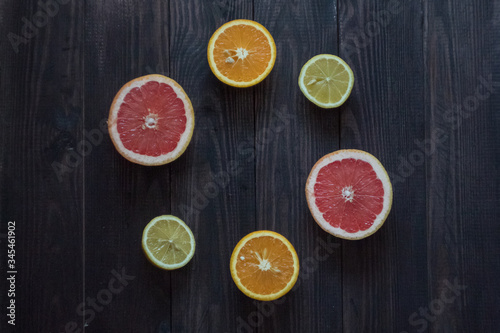 Fototapeta Naklejka Na Ścianę i Meble -  lemon, orange and grapefruit on a wooden background