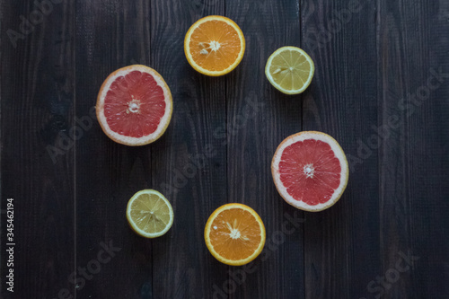 Fototapeta Naklejka Na Ścianę i Meble -  lemon, orange and grapefruit on a wooden background