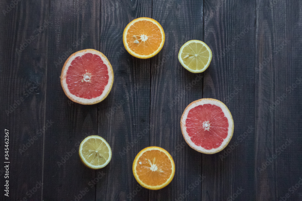 lemon, orange and grapefruit on a wooden background