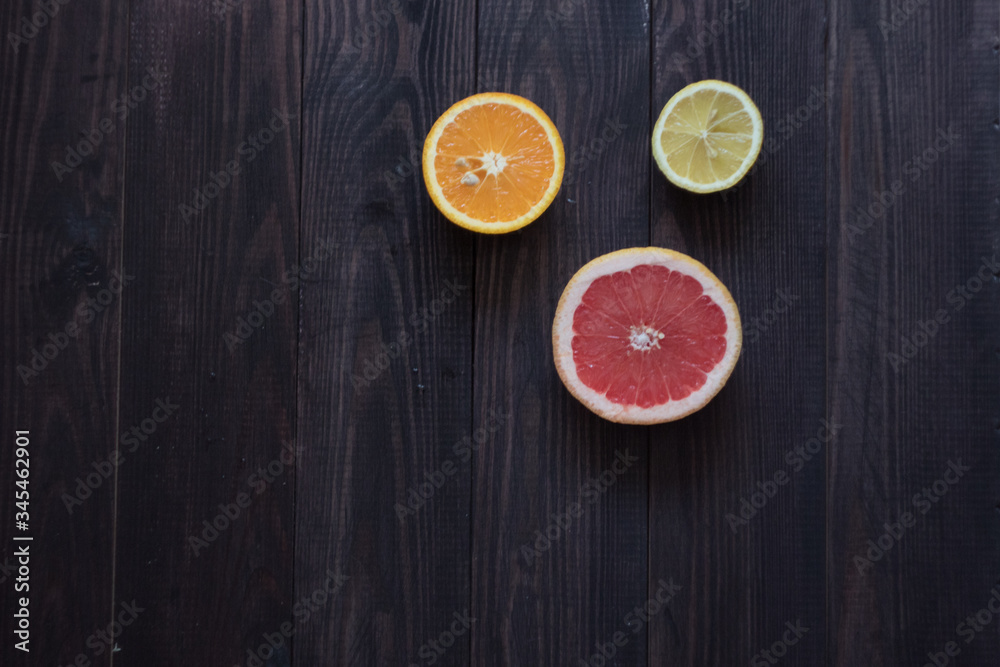 lemon, orange and grapefruit on a wooden background lemon, orange and grapefruit on a wooden background