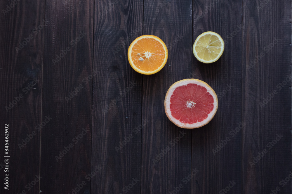 lemon, orange and grapefruit on a wooden background lemon, orange and grapefruit on a wooden background