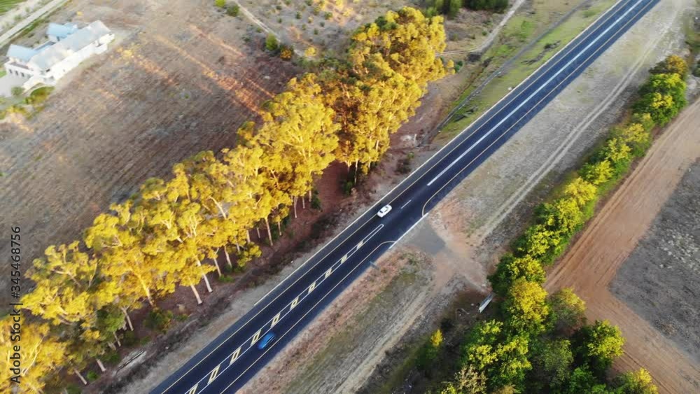 Aerial top down view of opposite cars driving on countryside road Aerial top down view of opposite cars driving on countryside road