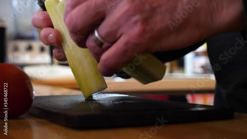 Cutting a Long Cucumber - Making a Salad in an Italian Kitchen 60fps Slow Motion photo