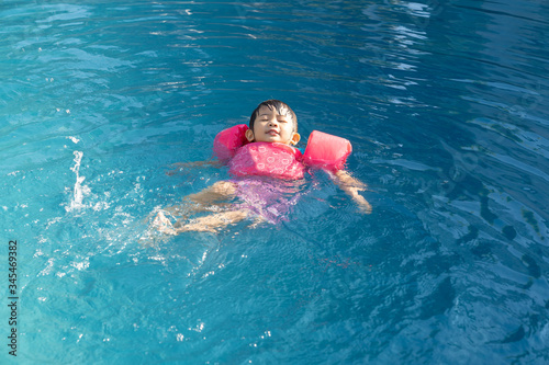 Girl happinese in swimming pool.