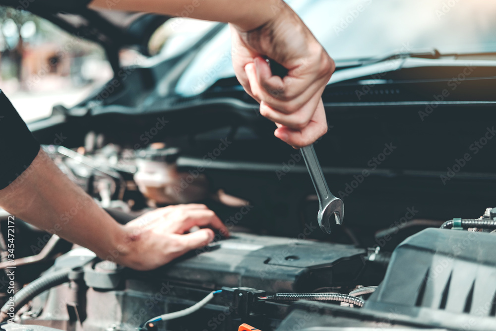 Auto mechanic working in garage Technician Hands of car mechanic working in auto repair Service and Maintenance car check.