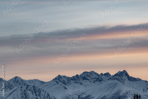 Stunning mountains seen in northern Canada, Yukon Territory at sunset in the winter with snow capped peaks. © Scalia Media