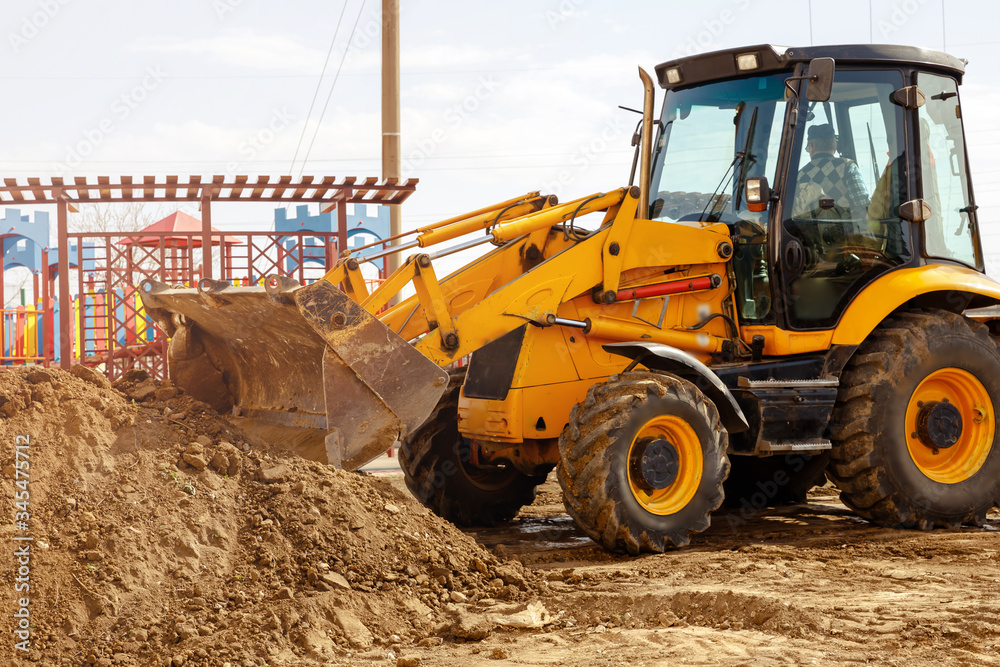 Excavator tractor digging a trench for pipenline at construction site Excavator tractor digging a trench for pipenline at construction site