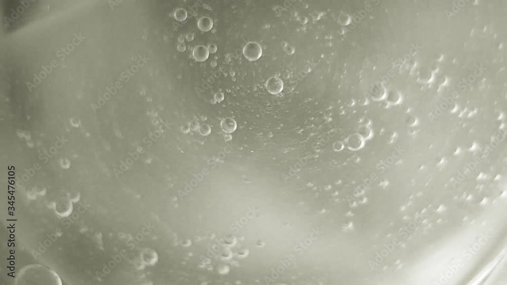 bubbles oil drops in motion on the water surface, gray abstract background