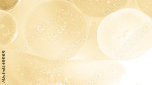 bubbles oil drops on the water surface abstract gold background