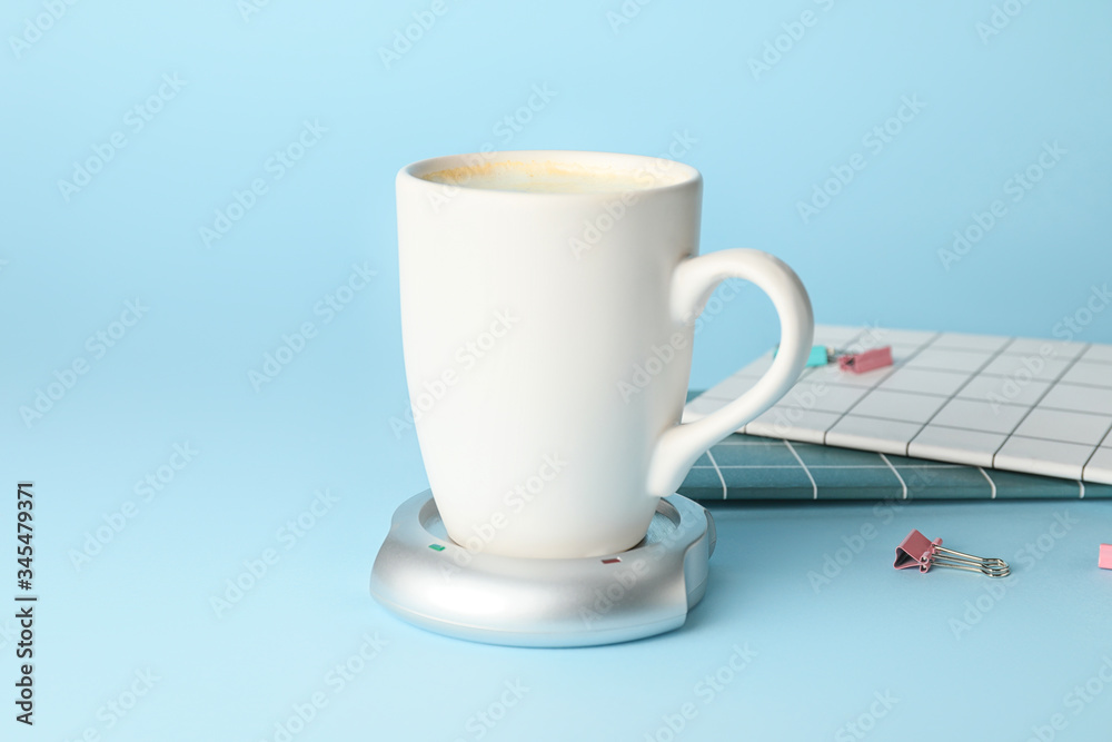 Cup of coffee with heater on color background Cup of coffee with heater on color background