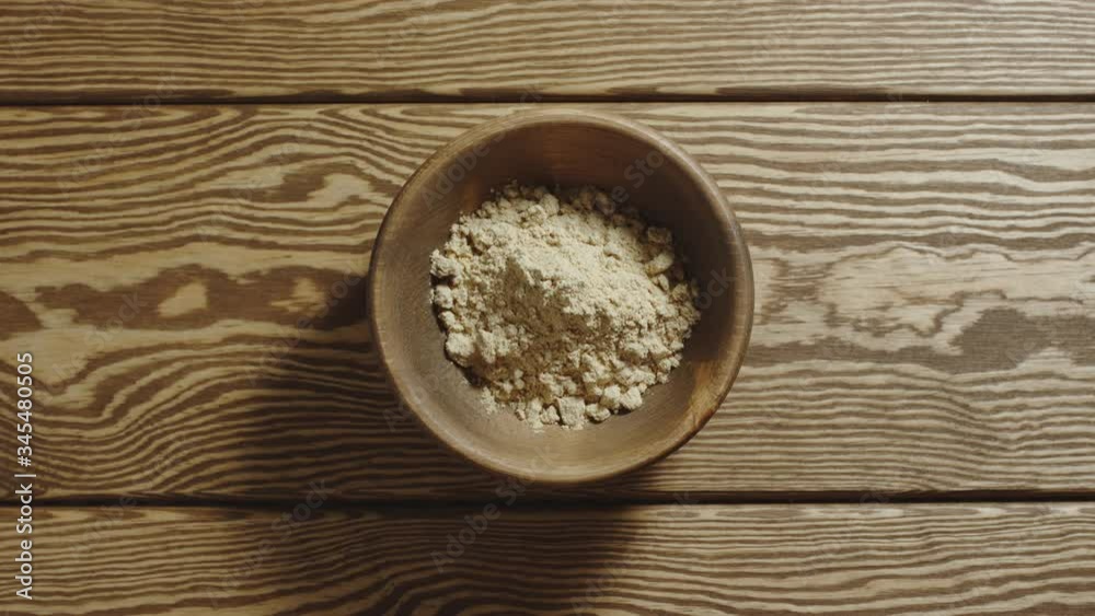 TOP VIEW: Ginger powder fill wooden cup. Stop motion TOP VIEW: Ginger powder fill wooden cup. Stop motion