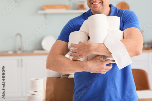Mature man with heap of toi...