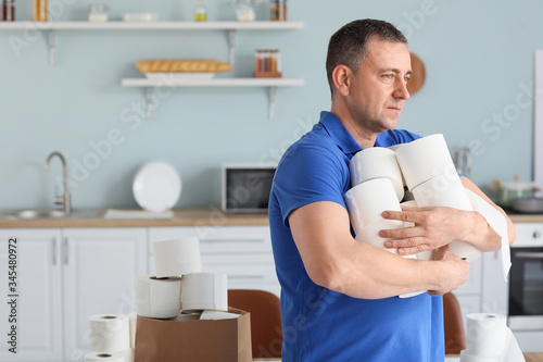 Mature man with heap of toi...