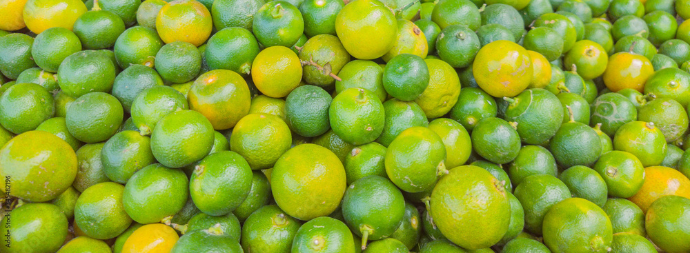 Green fresh whole ripe green tangerine as a texture. Food concept. Tropical and exotic fruits. Healthy and vitamin food. BANNER, LONG FORMAT