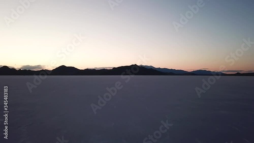 Cinematic Drone Pull Back Shot of Bonneville Salt Flats at Sunset, Utah photo