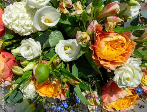 Wonderful bouquet with orange peonies and various flowers. Spring and colorful composition