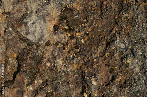 Stone texture with hard light, for design. Orange rock.Textured stone texture with hard light, for design. Orange rock.