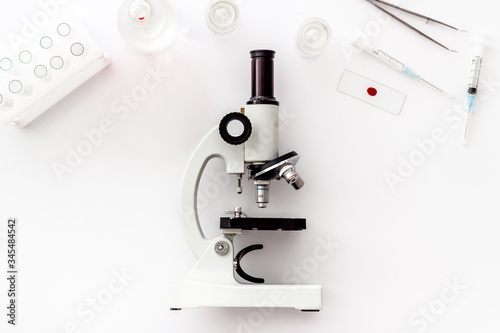 Laboratory examination with microscope. Equipment on white background top view