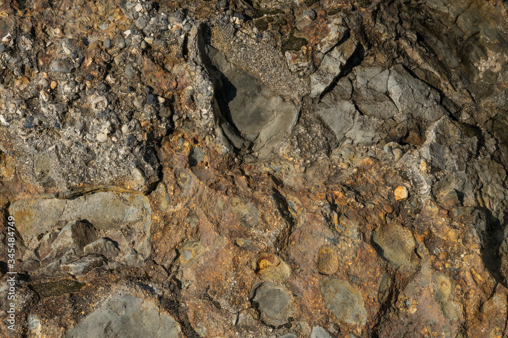 Textured stone texture with hard light, for design. Orange rock. Textured stone texture with hard light, for design. Orange rock.
