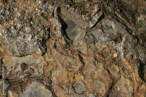 Textured stone texture with hard light, for design. Orange rock.