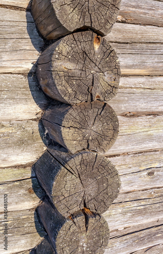 Corner of an old house made of round wooden logs Corner of an old house made of round wooden logs