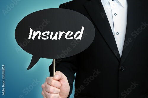 Insured. Lawyer in suit holds speech bubble at camera. The term Insured is in the sign. Symbol for law, justice, judgement