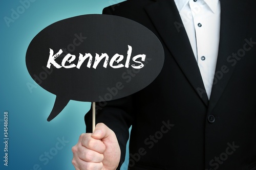 Kennels. Lawyer in suit holds speech bubble at camera. The term Kennels is in the sign. Symbol for law, justice, judgement