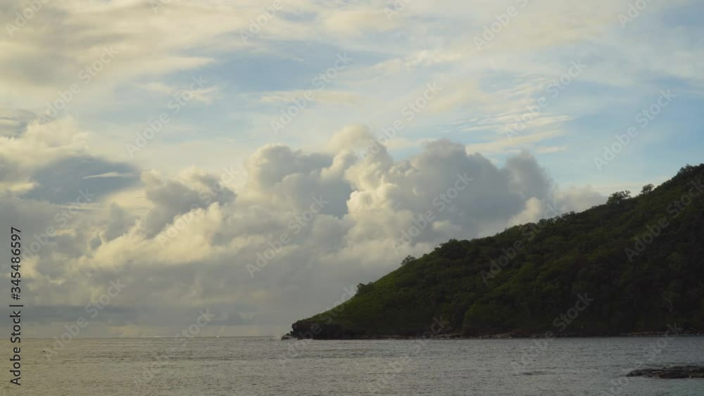 Island cliff filled with lush green jungle during dusk by ocean, static 4K, Fiji Island cliff filled with lush green jungle during dusk by ocean, static 4K, Fiji