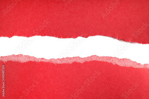 Ripped pieces of red paper isolated on white background. Paper piece torn edge.