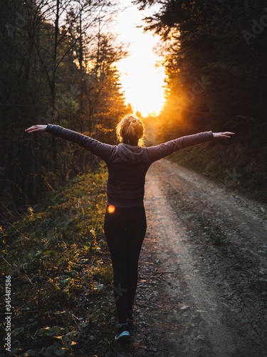 Happy woman raised her arms...