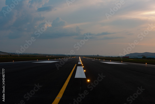 the runway of the airport at sunset