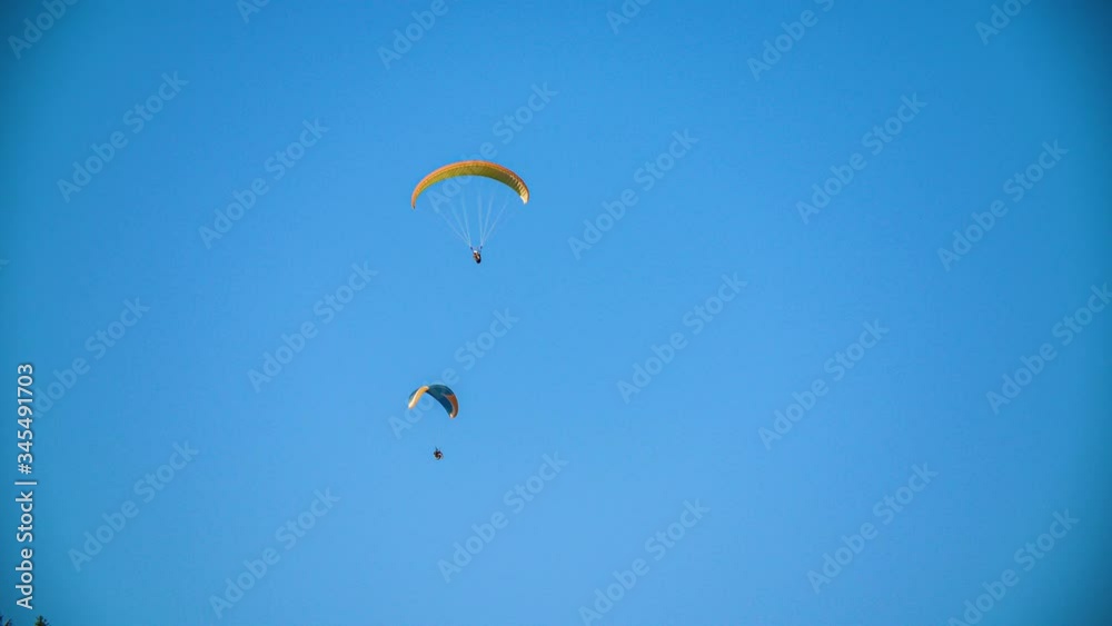 two paraglider manoeuvre smoothly on sky, extreme sports adventure two paraglider manoeuvre smoothly on sky, extreme sports adventure