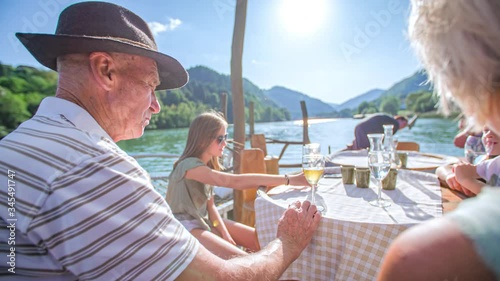 grandparents and grandchildren picnic at log raft, summer, Drava River, Muta photo