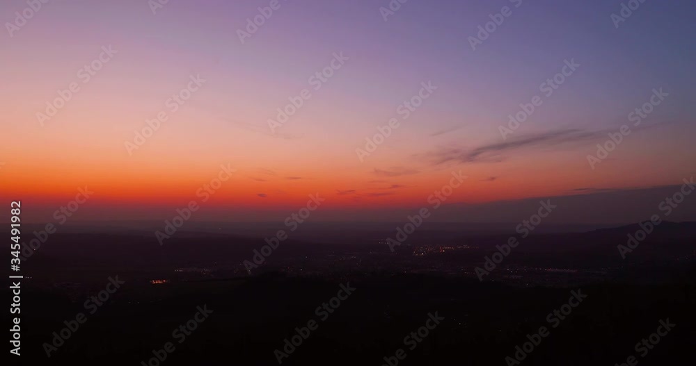 Dark sunset over a slowly lighting up the city when the network is red sky and the landscape is shrouded in dark black fog over the city of Valasske Mezirici in 4k 60fps Dark sunset over a slowly lighting up the city when the network is red sky and the landscape is shrouded in dark black fog over the city of Valasske Mezirici in 4k 60fps