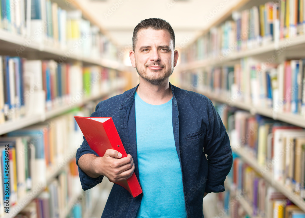 Young man wearing a blue outfit. Holding a red folder. Young man wearing a blue outfit. Holding a red folder.