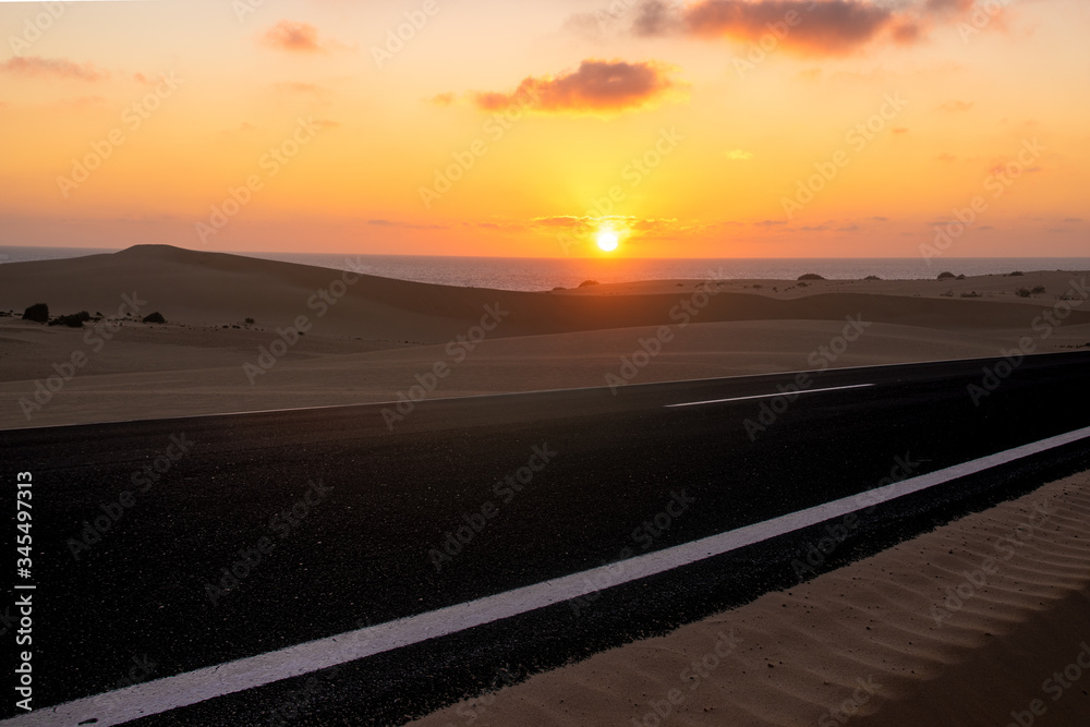 A scenic road running through the sands of Fuerteventura
