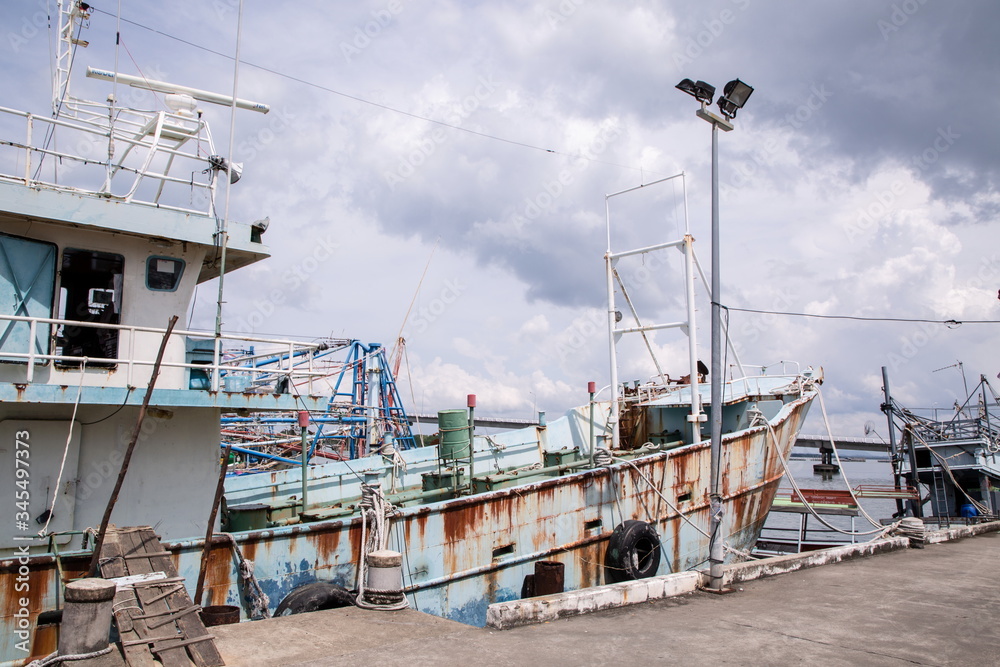 old rusty fisherman ship at port on river . old rusty fisherman ship at port on river .