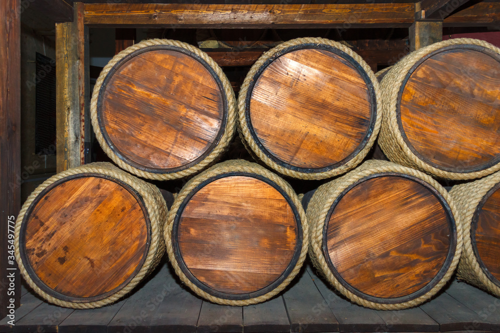 A cellar with wooden vintage barrels. Front view