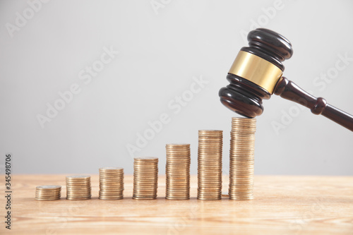 Stack of coins with judge gavel. photo