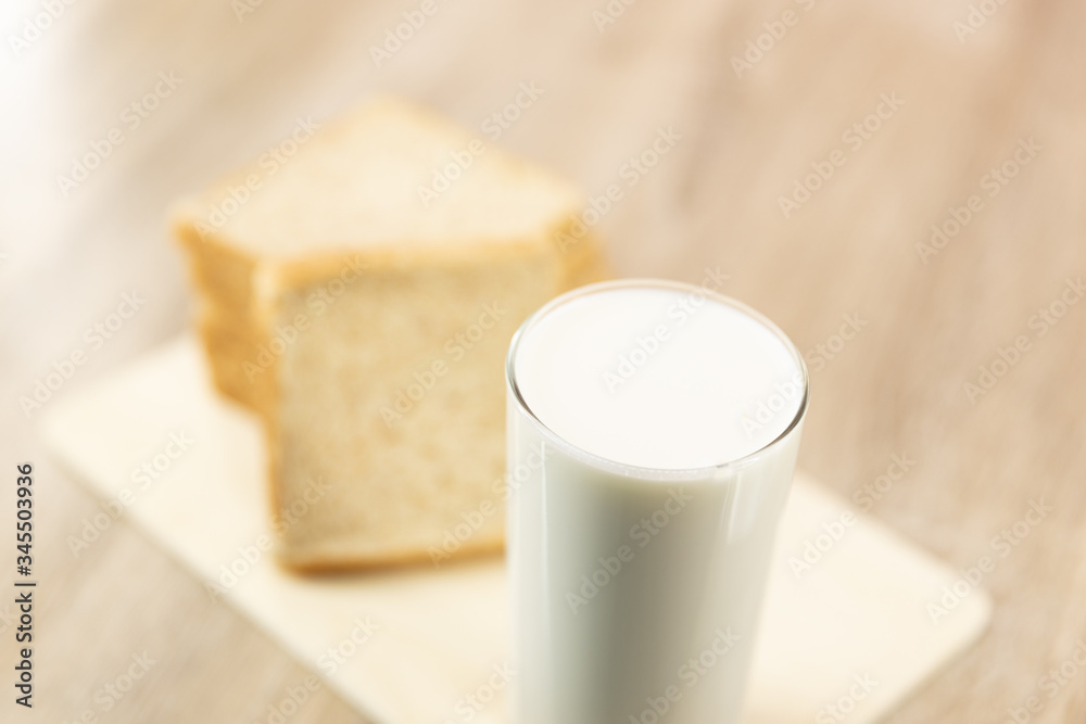 Close up fresh healthy milk and bread on pink background Close up fresh healthy milk and bread on pink background