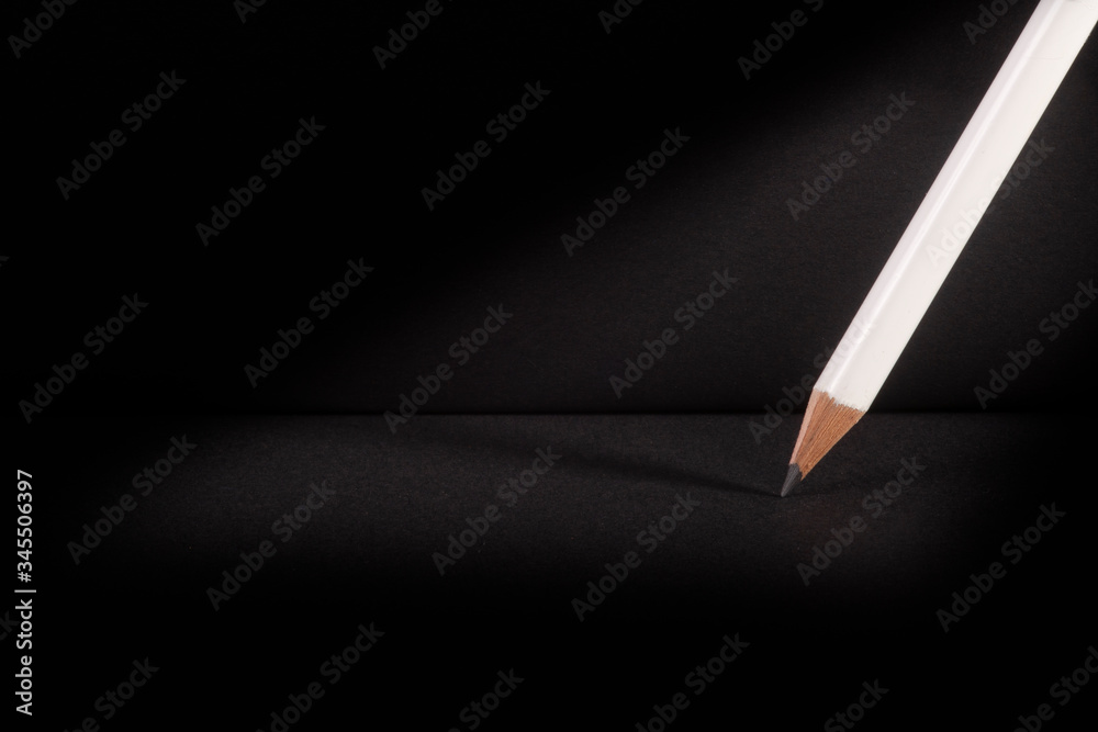 white pencils on black background white pencils on black background