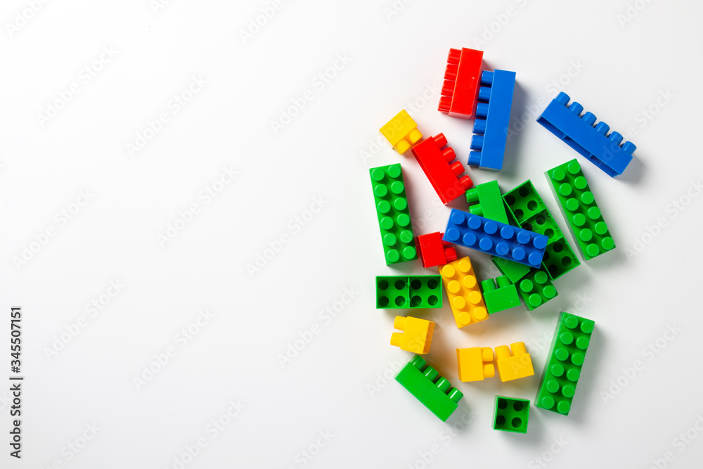 Multicolored designer parts on an isolated white background. Educational toys, logic. Banner. Flat lay, top view Multicolored designer parts on an isolated white background. Educational toys, logic. Banner. Flat lay, top view