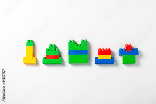 Houses of various shapes from the designer, multi-colored details on an isolated white background. Educational toys, logic, new construction, new building. Banner. Flat lay, top view