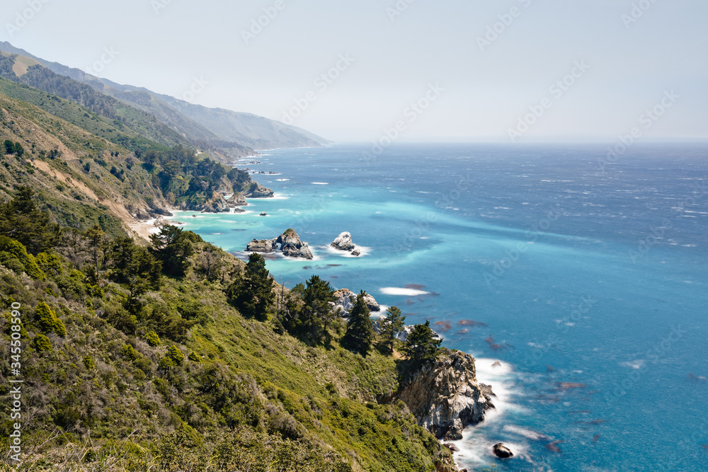 Big Sur, a popular touristic destination, famous for its dramatic scenery. Stunning view of  Pacific Ocean and native redwood forest.