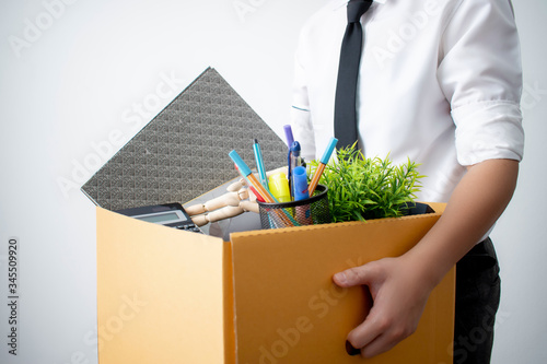 The employee was fired from carrying a brown cardboard box with his equipment. Concept of the unemployed and the economy photo