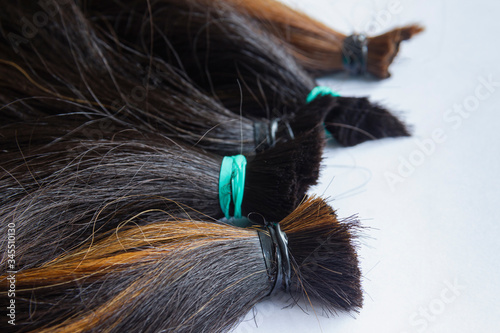 hair tied together for do wig on with background, donated to people with cancer