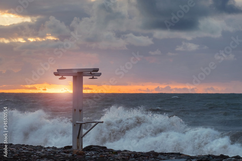 Shower on beach along the sea with sea and sunset sky background