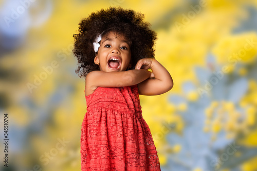 childhood and people concept-cheerful happy african american little girl over blurred background © len4foto