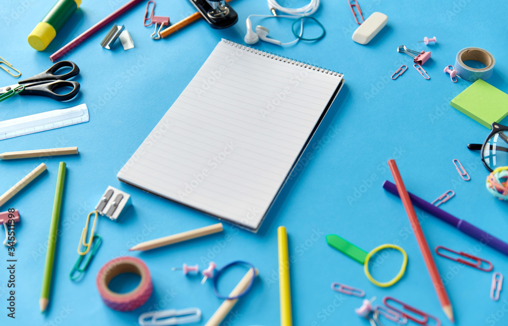 education, office and object concept - notebook and stationery or school supplies on blue background education, office and object concept - notebook and stationery or school supplies on blue background